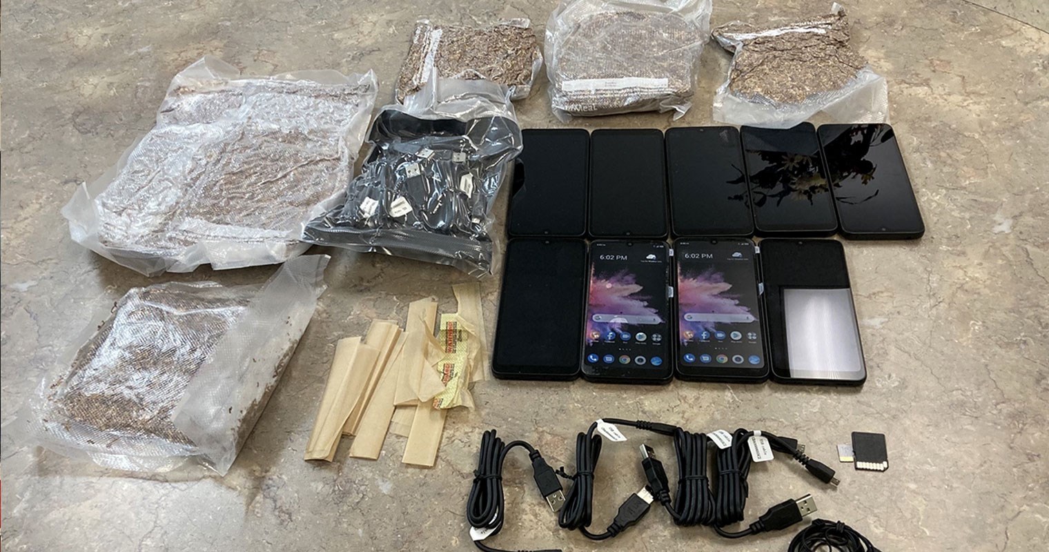 Contraband containing nine cell phones, five packages of tobacco, a package of cell phone charging adapters, two cell phone SIM cards, one pair of earbuds, tobacco wrapping papers and four additional charging cords.