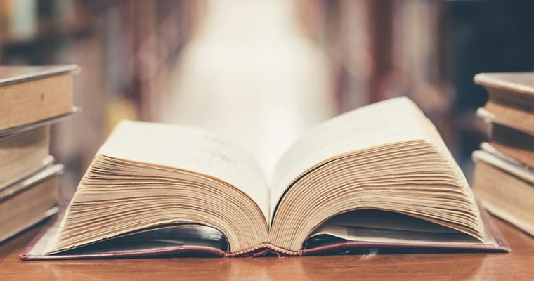 Open book laying on desk.