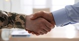 military personnel shaking hands with business professional