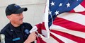 Correctional Officer holding United States flag